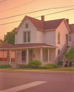 a white house sitting on the side of a road