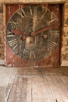 an old wooden clock with roman numerals on it