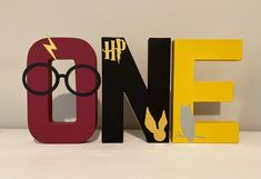 the word harry potter spelled out in wooden letters with lightning bolt on one side and black glasses on the other