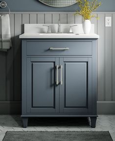 a bathroom vanity with two sinks and a mirror on the wall above it, along with a rug