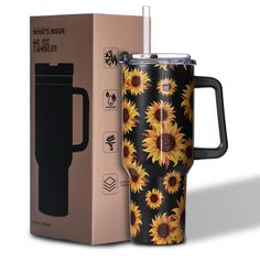 a black and yellow sunflower travel mug next to a cardboard box