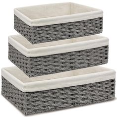 three grey wicker baskets stacked on top of each other, one with white linings