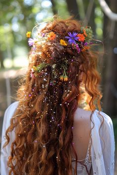 a woman with long red hair and flowers in her hair