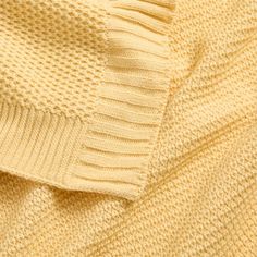 a close up view of a yellow sweater