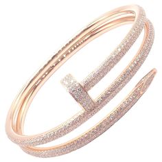 18k Rose Gold Diamond Juste Un Clou Nail Bangle Bracelet Size 16 by CARTIER. The Cartier Juste un Clou Nail Bangle is an exquisite bracelet crafted in 18k rose gold, adorned with sparkling diamonds. Shaped like a bent nail, it epitomizes bold elegance. This size 16 piece comes with papers, ensuring authenticity. A luxurious blend of modern design and timeless craftsmanship. With 624 round brilliant cut diamonds VVS1 clarity, E color total weight approximately 3.61ct Retail Price: $80,000 Details: Size: 16 Weight: 49.5 grams Width: Front 21mm, back 7mm Stamped Hallmarks: 750 Cartier 16 BSFXXX(serial number omitted) ***Free Shipping within the United States*** YOUR PRICE: $69,500 T3534eeoed Cartier Nail Bracelet, Cartier Diamond Bracelet, Rose Gold Nail, Cartier Juste Un Clou, Nail Bangle, Chanel Ring, Nail Bracelet, Nail It, Gold Nail