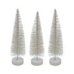 three white plastic christmas trees on stands