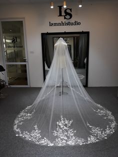 a wedding veil is hanging in front of the entrance to a clothing store that sells bridal gowns