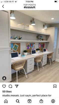 an office with two desks and three laptops on the same desk in front of a refrigerator