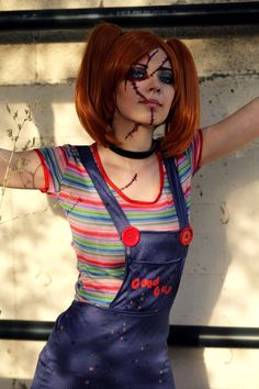 a woman with red hair and makeup wearing overalls