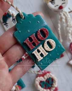 a hand holding a small ceramic ornament with the word do it on it