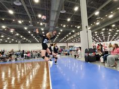 a volleyball player jumping up to hit the ball