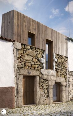 an old stone building with wooden doors and windows