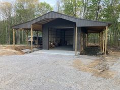 an empty garage in the middle of a wooded area