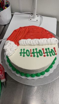 there is a cake that has been decorated with santa's hat and the words ho ho ho on it