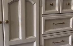 the cabinets are painted white and have gold handles