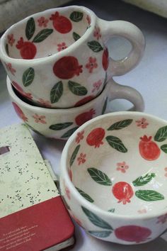 three cups and a book on a table