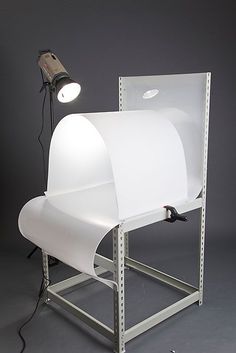 a light that is on top of a chair with a sheet of paper in front of it