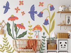 a baby's room with flowers and butterflies painted on the wall, including a crib