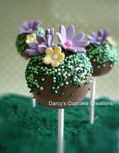 two cake pops decorated with flowers on top