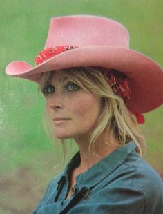 a woman wearing a pink cowboy hat and blue shirt