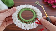 someone is crocheting a small christmas ornament