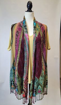 Be the life of the party with this multi-colored fringe vest! Step out in unique style with this show-stopping sleeveless statement piece. Perfect for adding a punch of color to any look, you won't ever be stuck in a style rut again! (Or, you know, just really make a statement.) Fitted Multicolor Sweater Vest For Fall, Multicolor Summer Sweater Vest, Fitted Multicolor Bohemian Vest, Multicolor Spring Vest, Multicolor Sweater Vest For Summer, Multicolor One Size Tops For Layering, One Size Multicolor Tops For Layering, Multicolor Sleeveless Vest For Fall, Festival Multicolor Vest Top