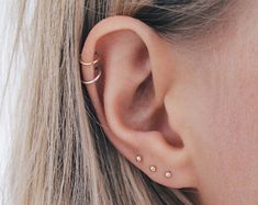 a close up of a person wearing an ear piercing