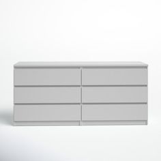 a white dresser sitting on top of a white floor