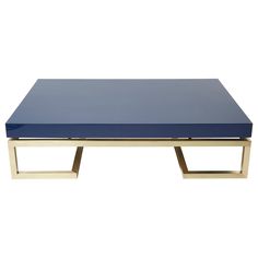 a blue table sitting on top of a white floor next to a metal frame and wooden legs