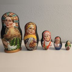 an assortment of russian nesting dolls sitting on a table