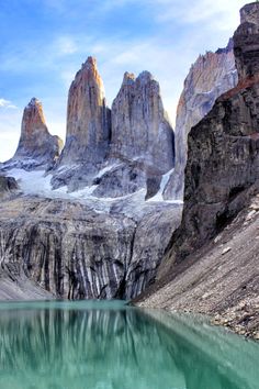 the mountains are covered in snow and green water