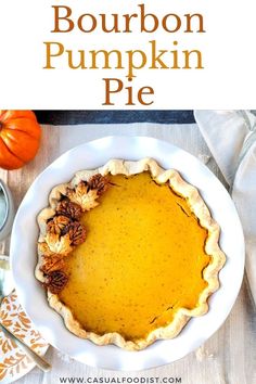 bourbon pumpkin pie on a white plate with the words bourbon pumpkin pie in front of it