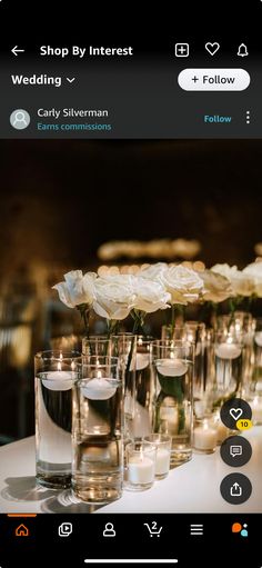 a table with candles and vases filled with flowers on top of it, in front of an instagram page