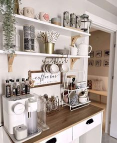 a kitchen counter with coffee cups and mugs on it, along with other items