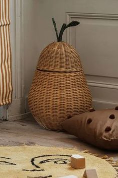 a stuffed animal sitting on the floor next to a basket