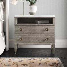 a nightstand with a potted plant on top