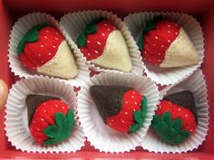 six chocolate covered strawberries are in the red box with white paper liners on them