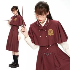 a woman in a school uniform holding a wand