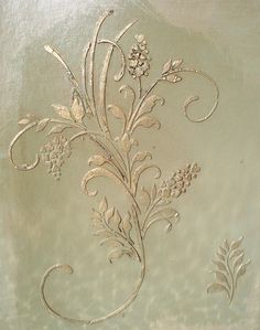 an ornate design on the side of a glass door with flowers and vines in it