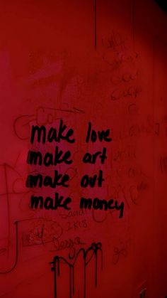 graffiti written on the side of a red wall with words that read, make love make art make out make money