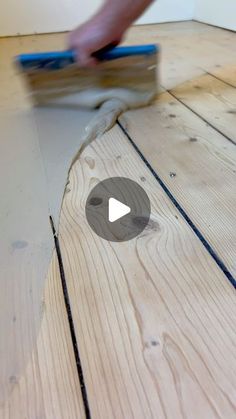 a person is sanding wood on the floor