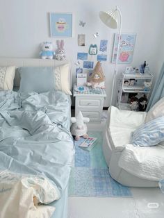 a bed room with a neatly made bed next to a night stand and two chairs