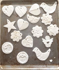 the cookies are decorated with white icing and have hearts, stars, and other ornaments