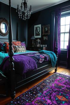 a bed with purple and blue comforters in a dark room next to a chandelier