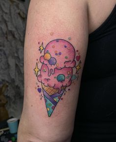 an ice cream cone with sprinkles and stars on it's arm