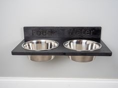 two stainless steel bowls with the words food water on them