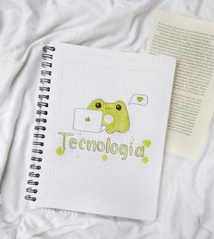 an open notebook sitting on top of a bed next to a paper with the word temologia written in it