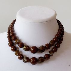 "Two strands of round chocolate brown beads clasp at back with a U-hook. Graduated in size to largest at front and interspersed with irregularly shaped semi-opaque golden sparkle beads. Excellent vintage condition. Beads have a nice shine and a free of scratches.  Gold metal fittings are slightly tarnished. All parts are firmly attached. Length at neck can be adjusted between 14.5\" and 17\" No identifying marks or labels" Dark Brown Jewelry, Elegant Luxury Brown Beads, Vintage Brown Adjustable Necklace, Vintage Single Strand Brown Necklace, Vintage Brown Necklaces With Polished Beads, Golden Sparkle, Elegant Multi-strand Brown Beads, Vintage Brown Multi-strand Beaded Necklace, Double Strand Necklace