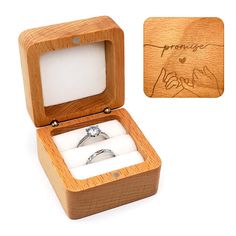 an open wooden box with a wedding ring inside and engraved on the lid, in front of a white background