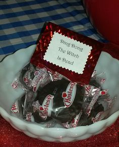 a white bowl filled with chocolate candies on top of a table